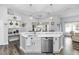 Bright kitchen island with stainless steel appliances, updated countertops, and breakfast bar seating at 2423 Turnberry Dr, Oviedo, FL 32765