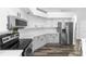 Well-lit kitchen with stainless steel appliances, white cabinets, and plenty of countertop space for cooking at 2423 Turnberry Dr, Oviedo, FL 32765