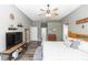 Spacious main bedroom with ceiling fan, TV, and ensuite bathroom entrance at 2423 Turnberry Dr, Oviedo, FL 32765