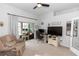 Office space with desk, lounge chair, and sliding glass doors to covered patio at 2423 Turnberry Dr, Oviedo, FL 32765