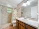 Bathroom featuring tiled walls, a shower with curtain, and updated vanity at 3300 Glen Village Ct, Orlando, FL 32822