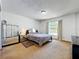 Bright bedroom with neutral carpet, large mirror dresser, and sunlit window at 3300 Glen Village Ct, Orlando, FL 32822