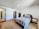 Bedroom featuring neutral carpet, mirrored dresser, and plenty of natural light at 3300 Glen Village Ct, Orlando, FL 32822