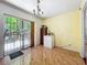 Bright dining room with sliding glass door to backyard and classic chandelier at 3300 Glen Village Ct, Orlando, FL 32822