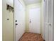 Entryway showing white doors, coat rack, and tiled flooring providing a welcoming space to enter the home at 3300 Glen Village Ct, Orlando, FL 32822