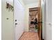 Hallway with tiled floor, showing the garage and closet at 3300 Glen Village Ct, Orlando, FL 32822