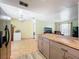 Open kitchen and dining area featuring a wood-topped island, adjacent to a cozy living space with natural light at 3300 Glen Village Ct, Orlando, FL 32822