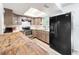 Bright kitchen with gray cabinets, stainless steel appliances, and a large refrigerator enhancing functionality at 3300 Glen Village Ct, Orlando, FL 32822