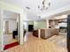 Open-concept living room and kitchen with tile floors and modern appliances at 3300 Glen Village Ct, Orlando, FL 32822