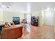 Cozy living room features tile flooring, an aquarium, comfortable seating, and a media center with large-screen TV at 3300 Glen Village Ct, Orlando, FL 32822