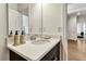 Modern bathroom featuring a dark wood vanity, quartz countertop, and ample lighting at 5793 Timber Meadow Way, St Cloud, FL 34771