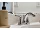Close-up of a bathroom faucet on a quartz countertop with soap and lotion dispensers at 5793 Timber Meadow Way, St Cloud, FL 34771