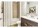 Bathroom with shower and tub, dark vanity, and quartz countertop at 5793 Timber Meadow Way, St Cloud, FL 34771