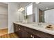 Bathroom featuring double sinks, modern faucets, a large mirror, vanity, and a bright window at 5793 Timber Meadow Way, St Cloud, FL 34771