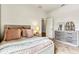 Bright bedroom featuring a cozy bed, dresser, and a view into the walk-in closet at 5793 Timber Meadow Way, St Cloud, FL 34771