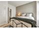 A well-lit bedroom with neutral-colored walls, an inviting bed, and view of the doorway at 5793 Timber Meadow Way, St Cloud, FL 34771