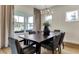 Dining area with a modern chandelier, large windows, neutral curtains, and a stylish decor at 5793 Timber Meadow Way, St Cloud, FL 34771