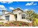 Well-maintained single-story house featuring a blue garage door, beautiful landscaping, and a inviting entrance at 5793 Timber Meadow Way, St Cloud, FL 34771