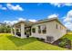 Exterior view of home with a covered patio, well-maintained lawn, and verdant landscaping at 5793 Timber Meadow Way, St Cloud, FL 34771