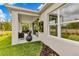 Exterior view of the home highlighting a covered patio, large window, and a manicured lawn at 5793 Timber Meadow Way, St Cloud, FL 34771