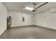 Spacious garage featuring a water heater, electrical panel and clean epoxy floor at 5793 Timber Meadow Way, St Cloud, FL 34771