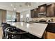 Bright kitchen boasts a large quartz island, stainless steel appliances, and stylish pendant lighting at 5793 Timber Meadow Way, St Cloud, FL 34771