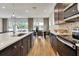 Spacious kitchen with an island that overlooks a dining area with large windows and access to the lanai at 5793 Timber Meadow Way, St Cloud, FL 34771