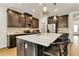Well-equipped kitchen with stainless steel appliances, a center island, and ample counter space at 5793 Timber Meadow Way, St Cloud, FL 34771