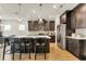 Modern kitchen featuring dark cabinetry, stainless steel appliances, and a large island with seating at 5793 Timber Meadow Way, St Cloud, FL 34771