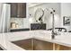 Close-up on a kitchen island featuring a stainless steel sink, modern faucet, and stylish decor at 5793 Timber Meadow Way, St Cloud, FL 34771