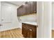 Functional laundry room with dark cabinets, ample counter space, and tile flooring at 5793 Timber Meadow Way, St Cloud, FL 34771