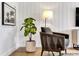 Cozy sitting area showcases a comfortable chair, stylish lamp, elegant decor, and wood flooring at 5793 Timber Meadow Way, St Cloud, FL 34771