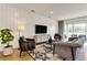 Comfortable living room with modern furniture, a large TV, stylish decor, and sliding glass doors at 5793 Timber Meadow Way, St Cloud, FL 34771