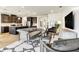 Open-concept living room with modern furnishings, stylish decor, and a view of the kitchen at 5793 Timber Meadow Way, St Cloud, FL 34771