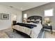 Spacious bedroom with decorative pillows, gray accent wall, and a view of the en-suite bathroom at 5793 Timber Meadow Way, St Cloud, FL 34771