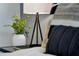 Stylish nightstand with a modern lamp, decorative plant, and a book, creating a cozy bedroom ambiance at 5793 Timber Meadow Way, St Cloud, FL 34771
