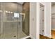 Modern walk-in shower with gray tile, glass door, and a contemporary showerhead at 5793 Timber Meadow Way, St Cloud, FL 34771