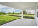Covered back patio offering a serene view of lush greenery and a tranquil pond at 2199 Broadbrook Drive, St Cloud, FL 34771