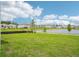 Backyard view overlooking the pond and neighborhood landscape, providing a peaceful outdoor setting at 2199 Broadbrook Drive, St Cloud, FL 34771