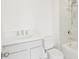 Bright bathroom featuring white marble style tile, a shower and tub combo, and a white sink and vanity at 2199 Broadbrook Drive, St Cloud, FL 34771