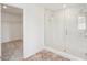 Bright bathroom features an open shower with white tile, and doorway to a walk-in closet at 2199 Broadbrook Drive, St Cloud, FL 34771