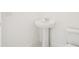 Small bathroom featuring a pedestal sink, toilet, and base trim at 2199 Broadbrook Drive, St Cloud, FL 34771