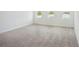 Bright bedroom with plush carpeting and views of a peaceful lake through three large windows at 2199 Broadbrook Drive, St Cloud, FL 34771