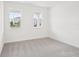 Bright, carpeted bedroom with ample natural light from large windows at 2199 Broadbrook Drive, St Cloud, FL 34771
