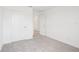 Minimalist bedroom featuring plush carpeting, clean white walls, white base trim, and a white closet door at 2199 Broadbrook Drive, St Cloud, FL 34771