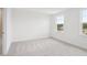 Bright bedroom with neutral carpeting, white walls, and two large windows at 2199 Broadbrook Drive, St Cloud, FL 34771