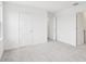 Bright bedroom features neutral carpeting and white walls, with doorways visible at 2199 Broadbrook Drive, St Cloud, FL 34771