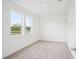 Spacious bedroom with two large windows showcasing the outside views and plush carpeting at 2199 Broadbrook Drive, St Cloud, FL 34771