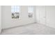 Bright bedroom features neutral carpeting, white walls and two windows at 2199 Broadbrook Drive, St Cloud, FL 34771