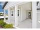 Inviting covered porch featuring sturdy white columns and a modern front door entrance at 2199 Broadbrook Drive, St Cloud, FL 34771